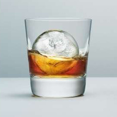 spherical ice cube in glass